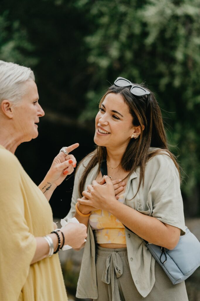 Two women talking at a garden gathering