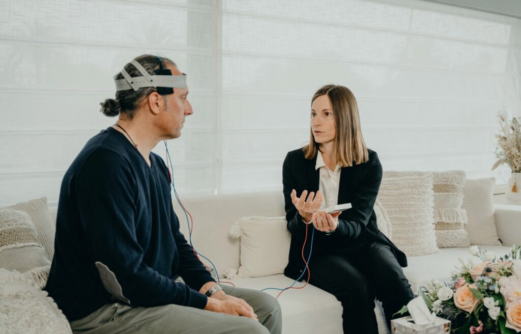 Person wearing a sensor headset during a seated conversation