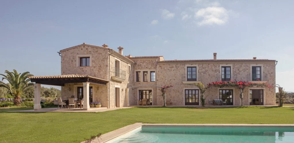 Stone residence beside a swimming pool